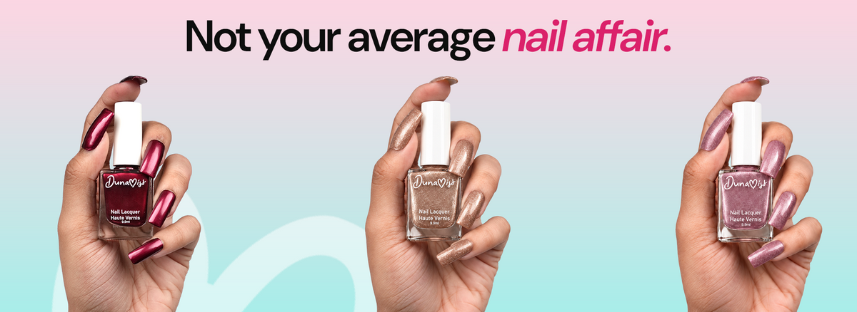 An elegant adult South Asian hand resting on ivory silk, five anatomically correct fingers, short rounded nails with a glossy rich burgundy manicure, soft blush daylight, no bottles.